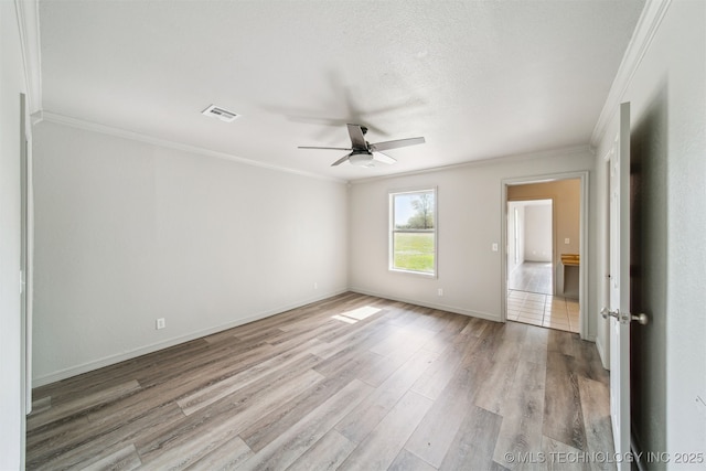 9839 N Lewis Ave, Sperry, OK 74073 - spare room featuring visible vents, ornamental molding, wood finished floors, baseboards, and ceiling fan