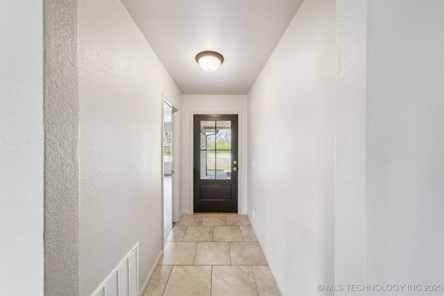 9839 N Lewis Ave, Sperry, OK 74073 - entryway featuring light tile patterned floors, baseboards, a textured wall, and visible vents