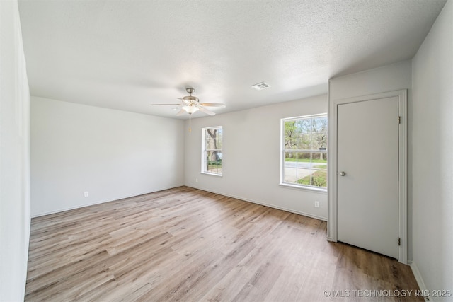 9839 N Lewis Ave, Sperry, OK 74073 - unfurnished room with baseboards, ceiling fan, light wood-style flooring, and visible vents