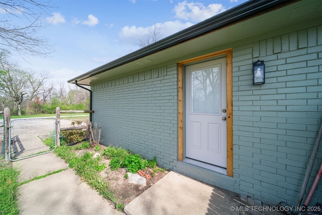 9839 N Lewis Ave, Sperry, OK 74073 - view of exterior entry featuring brick siding and a gate