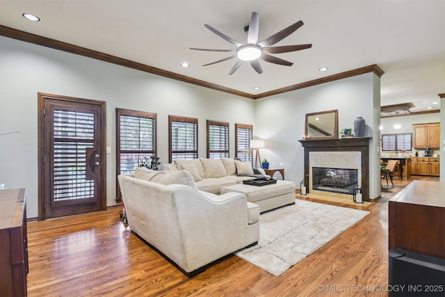 626 Countrywood Way, Sapulpa, OK 74066 - living room with a ceiling fan, ornamental molding, light wood-style floors, a high end fireplace, and recessed lighting