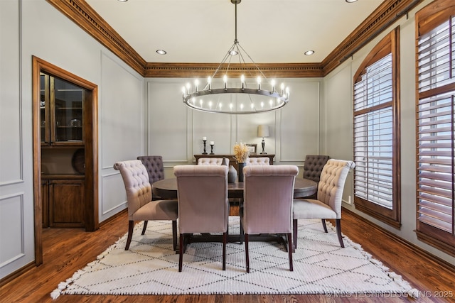 626 Countrywood Way, Sapulpa, OK 74066 - dining area featuring a chandelier, ornamental molding, a decorative wall, and wood finished floors