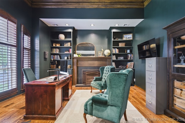 626 Countrywood Way, Sapulpa, OK 74066 - office area featuring a fireplace, built in features, ornamental molding, and wood finished floors
