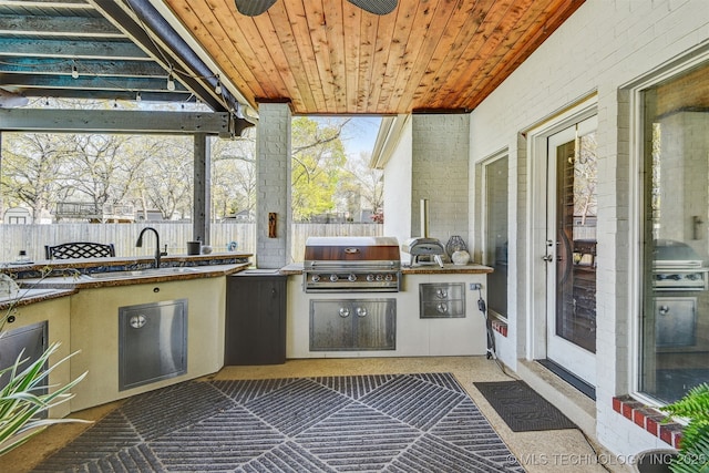 626 Countrywood Way, Sapulpa, OK 74066 - fenced backyard with an outdoor kitchen and a sink