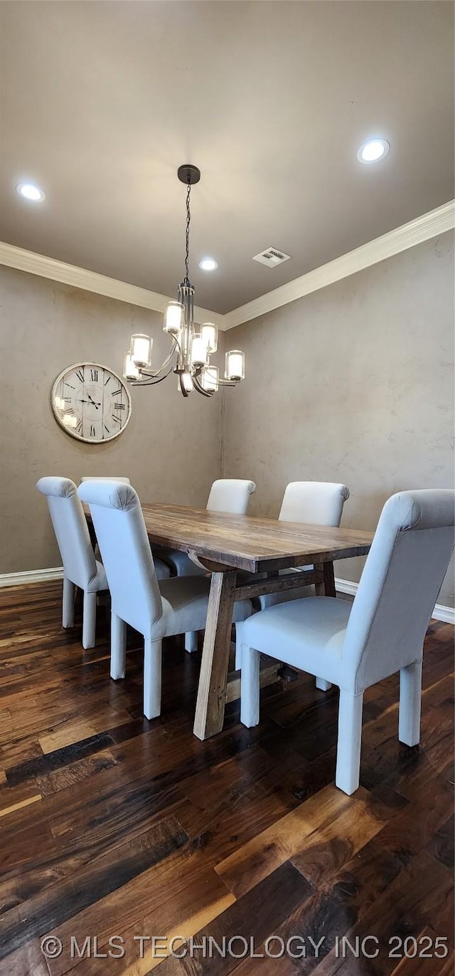 dining room with recessed lighting, wood finished floors, crown molding, and a notable chandelier