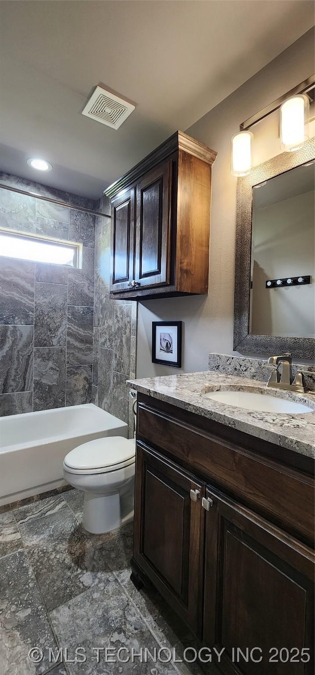full bath featuring toilet, vanity, and visible vents