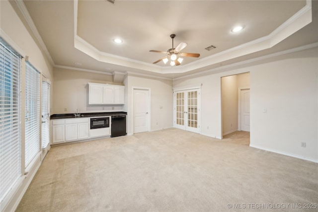 6673 E 60th Pl, Tulsa, OK 74145 - unfurnished living room featuring a raised ceiling, ceiling fan, ornamental molding, recessed lighting, and light carpet