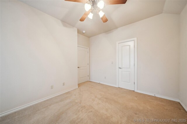 6673 E 60th Pl, Tulsa, OK 74145 - unfurnished bedroom featuring vaulted ceiling, light colored carpet, baseboards, and a ceiling fan