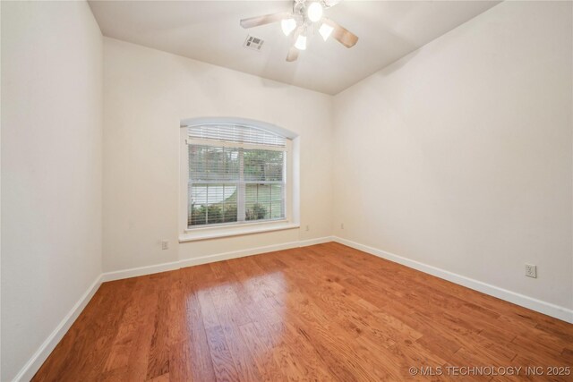 6673 E 60th Pl, Tulsa, OK 74145 - unfurnished room with wood finished floors, a ceiling fan, baseboards, and lofted ceiling