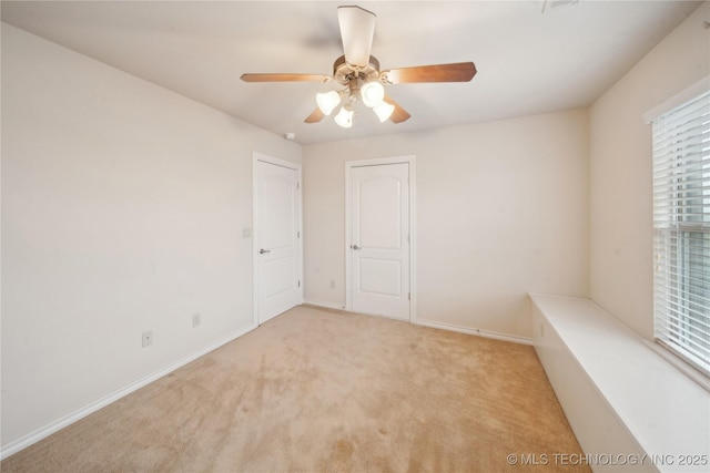 6673 E 60th Pl, Tulsa, OK 74145 - spare room featuring ceiling fan, carpet, and baseboards