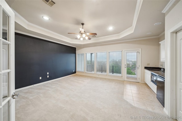 6673 E 60th Pl, Tulsa, OK 74145 - unfurnished living room featuring a tray ceiling, a ceiling fan, a sink, light colored carpet, and recessed lighting