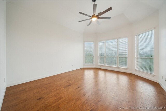 6673 E 60th Pl, Tulsa, OK 74145 - unfurnished room with wood finished floors, baseboards, a ceiling fan, and high vaulted ceiling