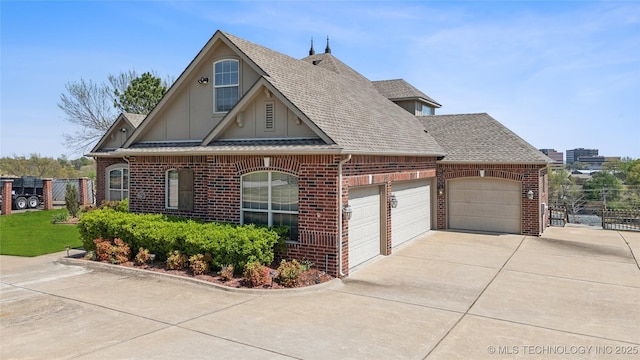 6673 E 60th Pl, Tulsa, OK 74145 - view of front facade featuring brick siding, driveway, a shingled roof, board and batten siding, and a garage