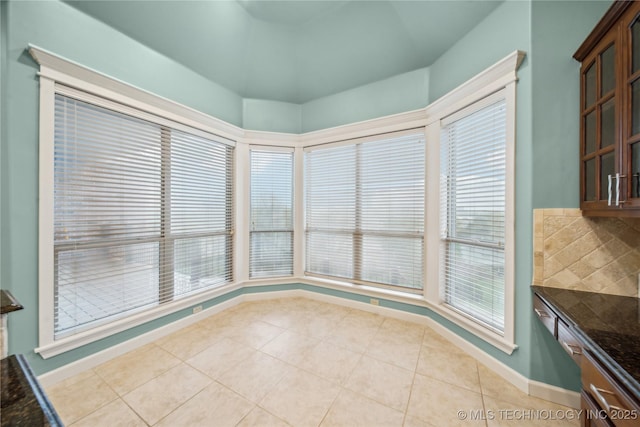 6673 E 60th Pl, Tulsa, OK 74145 - unfurnished dining area featuring light tile patterned floors and baseboards