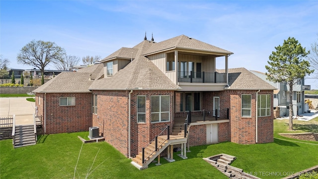 6673 E 60th Pl, Tulsa, OK 74145 - back of property featuring a balcony, brick siding, a lawn, board and batten siding, and stairs