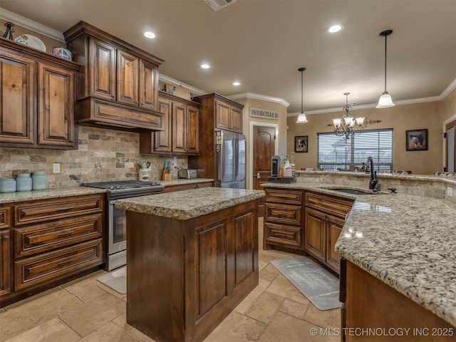 kitchen with stone tile flooring, a sink, appliances with stainless steel finishes, and crown molding