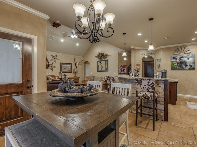 dining area featuring stone tile flooring, arched walkways, visible vents, lofted ceiling, and a ceiling fan