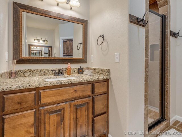 bathroom featuring vanity and a stall shower