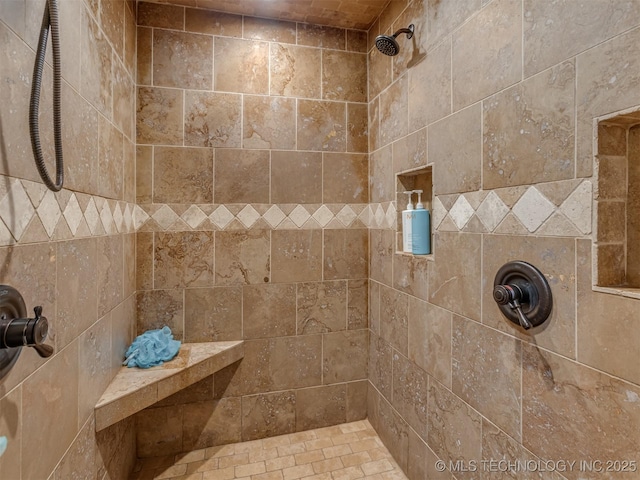 bathroom with tiled shower