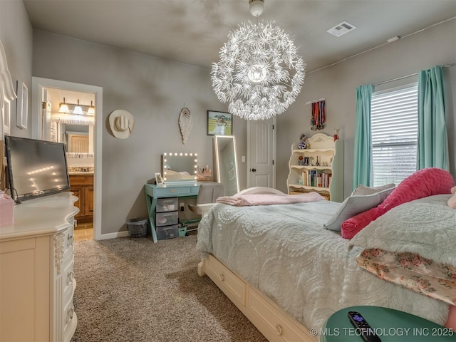 bedroom with visible vents, an inviting chandelier, light colored carpet, and connected bathroom