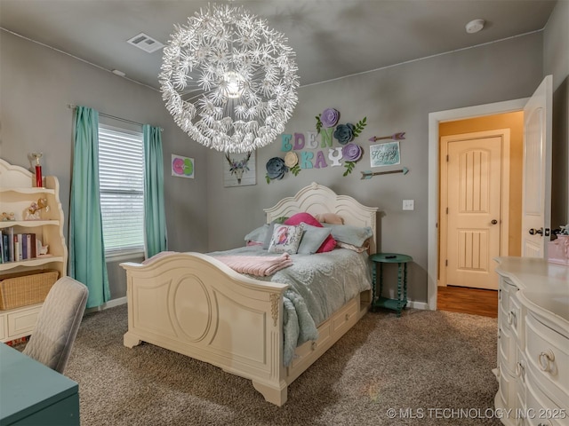 carpeted bedroom featuring baseboards, a chandelier, and visible vents