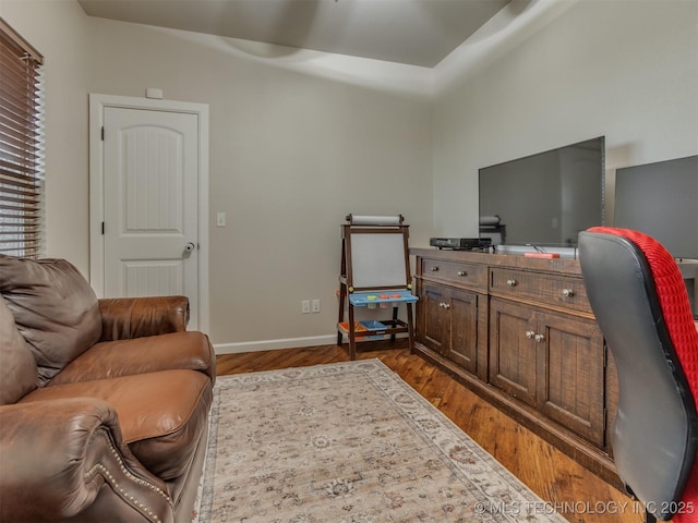 home office with baseboards and dark wood-style flooring