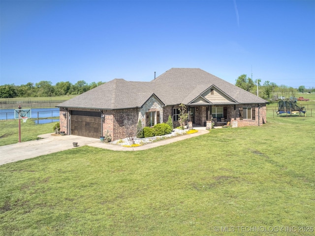 view of front of home featuring a garage, concrete driveway, fence, a front yard, and brick siding