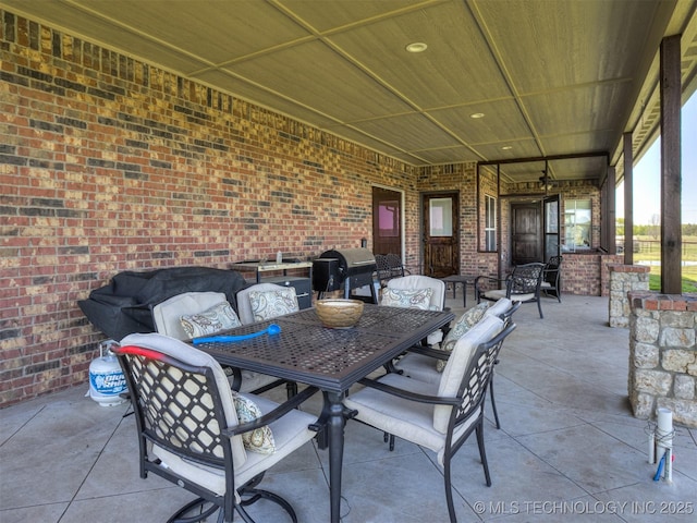 view of patio / terrace featuring outdoor dining area and a grill