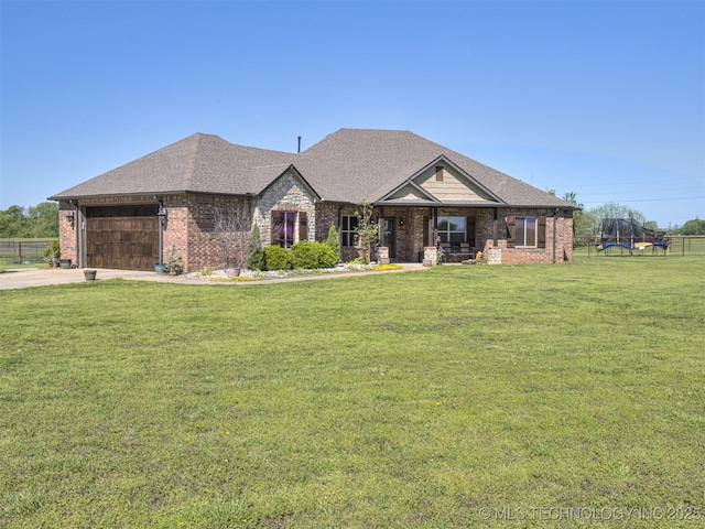 view of front facade featuring a front lawn, roof with shingles, concrete driveway, brick siding, and a garage