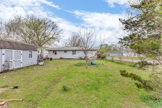 view of yard with a storage shed and an outbuilding