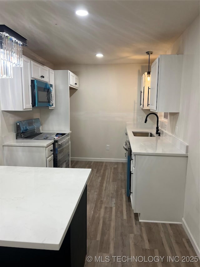 4232 N Hartford Ave, Tulsa, OK 74106 - kitchen with light countertops, electric range, a sink, and dark wood-style floors