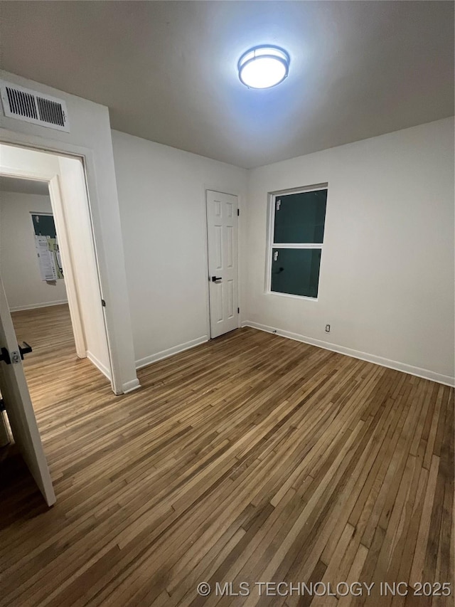 4232 N Hartford Ave, Tulsa, OK 74106 - spare room featuring wood finished floors, baseboards, and visible vents