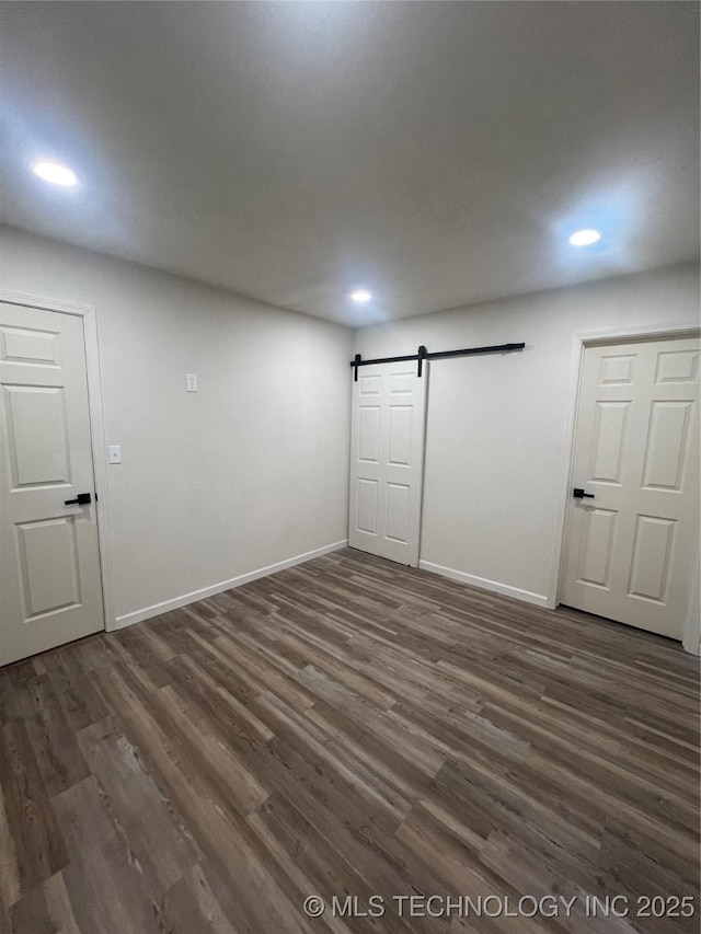 4232 N Hartford Ave, Tulsa, OK 74106 - basement featuring baseboards, recessed lighting, a barn door, and dark wood finished floors