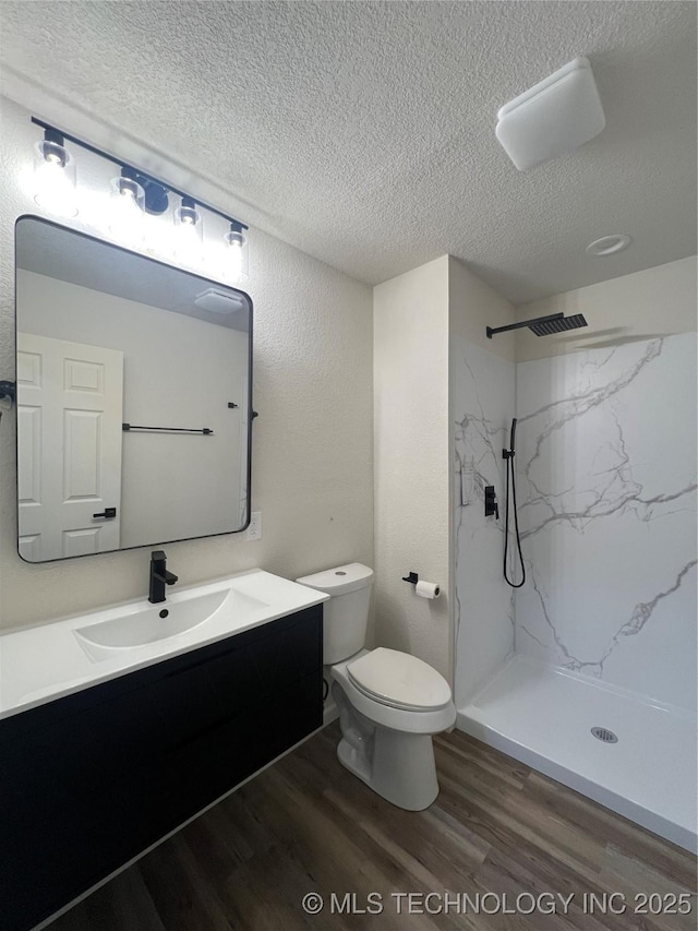 4232 N Hartford Ave, Tulsa, OK 74106 - full bathroom with a marble finish shower, toilet, vanity, and wood finished floors