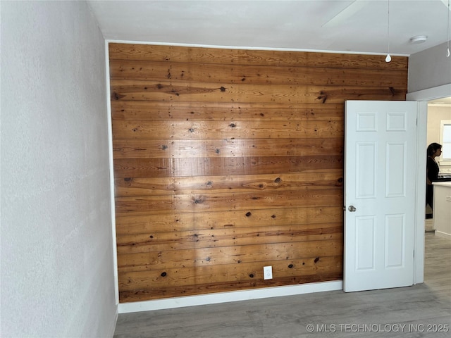 218 SW B, Ardmore, OK 73401 - empty room with wooden walls, a smoke detector, and wood finished floors