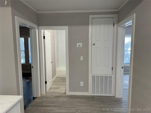 218 SW B, Ardmore, OK 73401 - corridor featuring crown molding, wood finished floors, baseboards, and plenty of natural light
