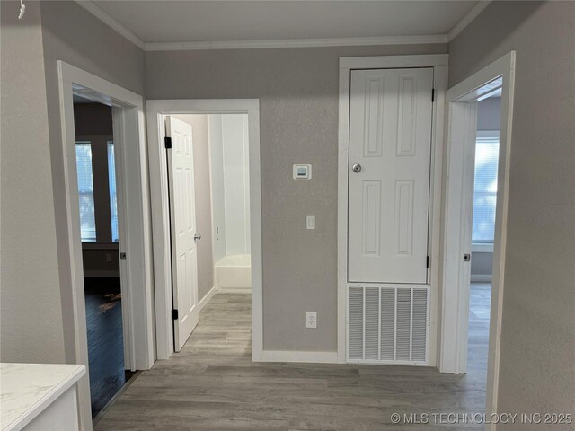 218 SW B, Ardmore, OK 73401 - corridor featuring crown molding, wood finished floors, baseboards, and plenty of natural light