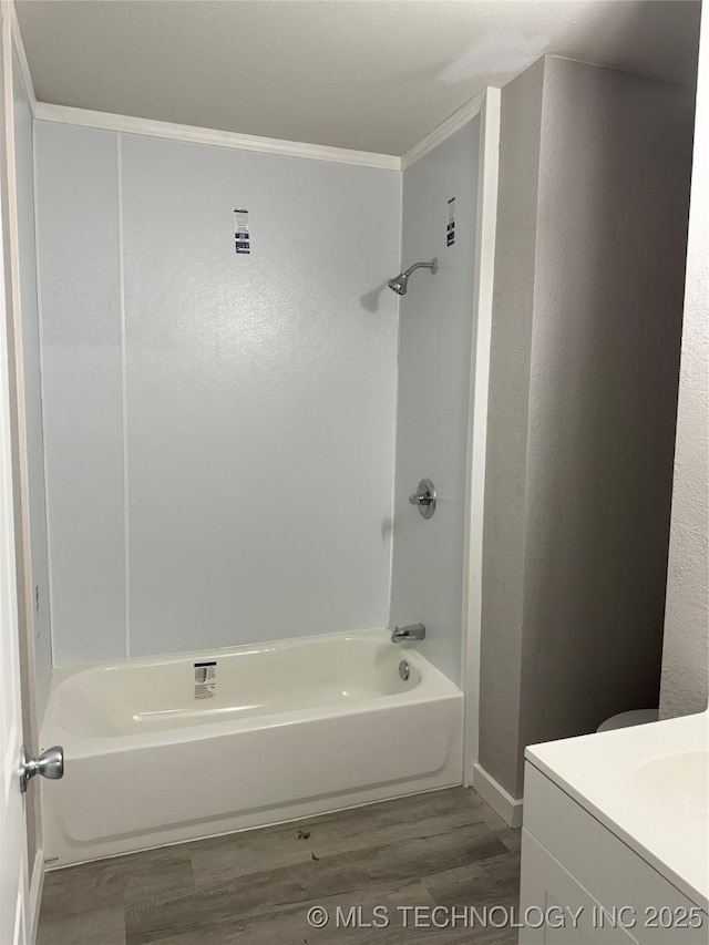 218 SW B, Ardmore, OK 73401 - bathroom with wood finished floors, shower / washtub combination, ornamental molding, vanity, and baseboards