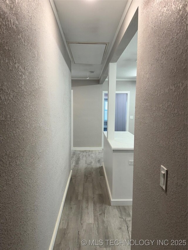 218 SW B, Ardmore, OK 73401 - hall featuring a textured wall, attic access, wood finished floors, and baseboards