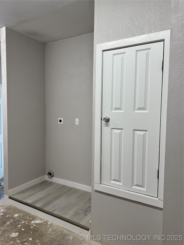 218 SW B, Ardmore, OK 73401 - laundry room featuring hookup for an electric dryer and baseboards
