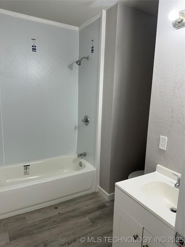 218 SW B, Ardmore, OK 73401 - bathroom with crown molding, wood finished floors, shower / tub combination, vanity, and baseboards