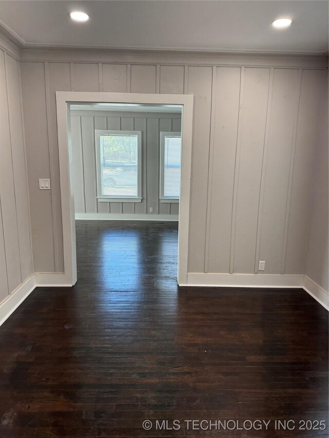218 SW B, Ardmore, OK 73401 - unfurnished room featuring a decorative wall, baseboards, dark wood-style flooring, and recessed lighting