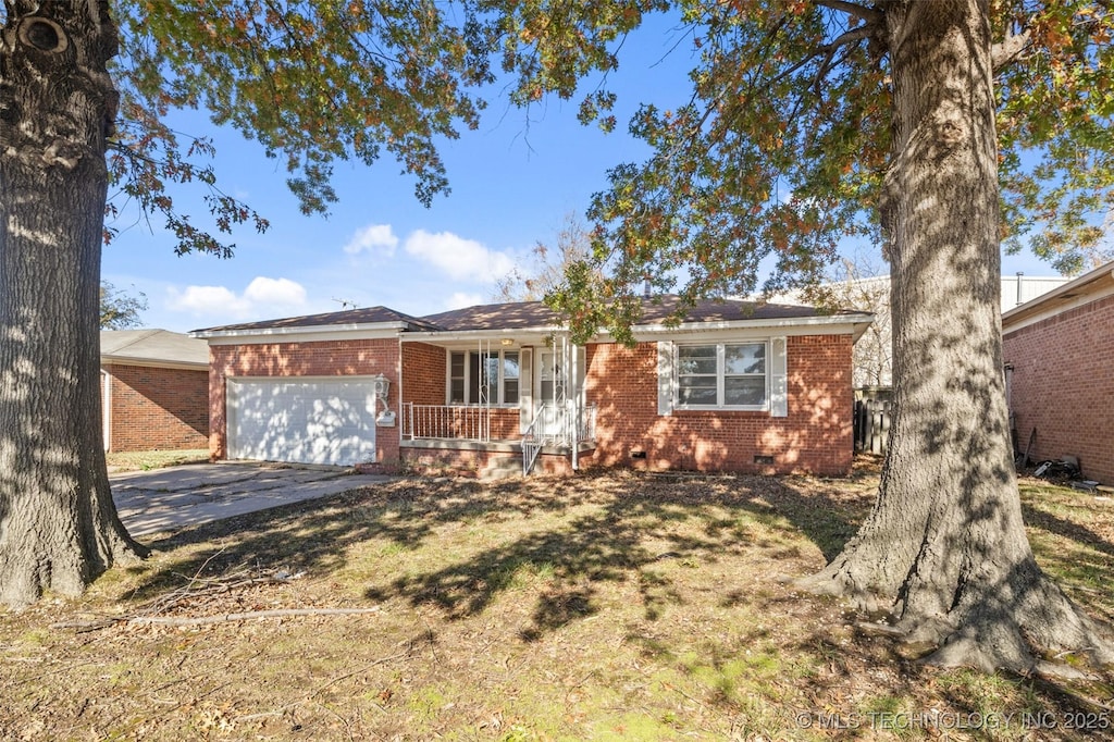 ranch-style house featuring brick siding, crawl space, driveway, and a garage