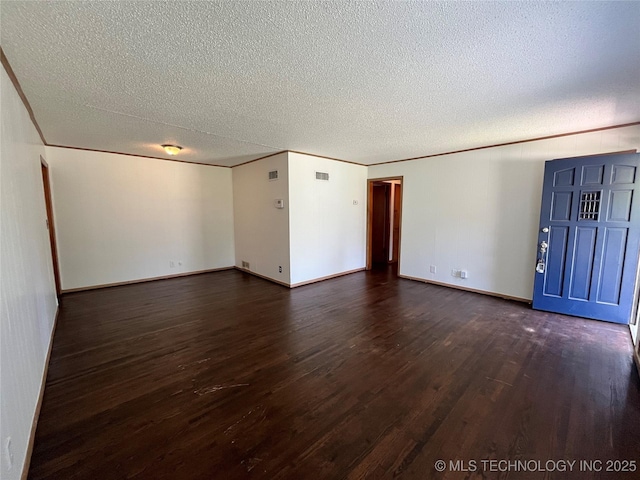1421 E 50th St S, Tulsa, OK 74105 - empty room featuring dark wood finished floors, a textured ceiling, and baseboards