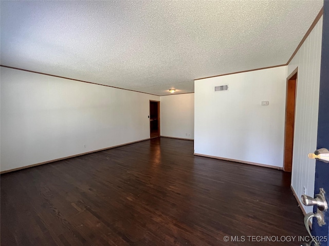 1421 E 50th St S, Tulsa, OK 74105 - empty room with wood finished floors, a textured ceiling, ornamental molding, and baseboards