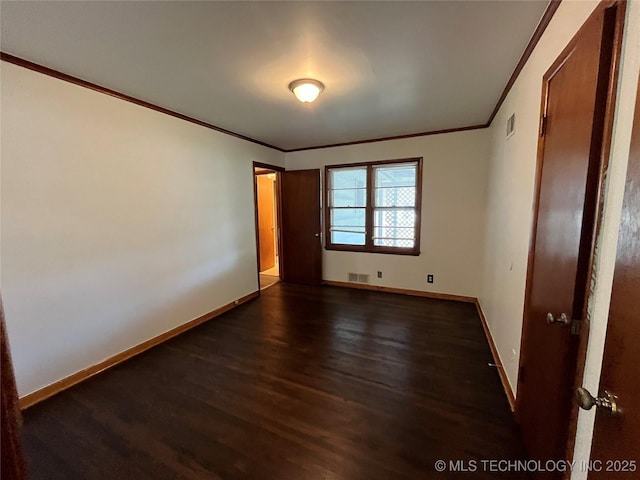 1421 E 50th St S, Tulsa, OK 74105 - unfurnished bedroom featuring crown molding, dark wood-type flooring, and baseboards