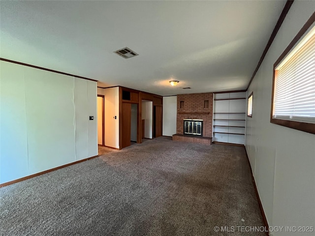 1421 E 50th St S, Tulsa, OK 74105 - unfurnished living room featuring carpet floors, a brick fireplace, and baseboards