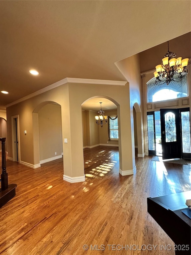 10213 S 88th E Ave, Tulsa, OK 74133 - entrance foyer with a chandelier, arched walkways, crown molding, wood finished floors, and recessed lighting