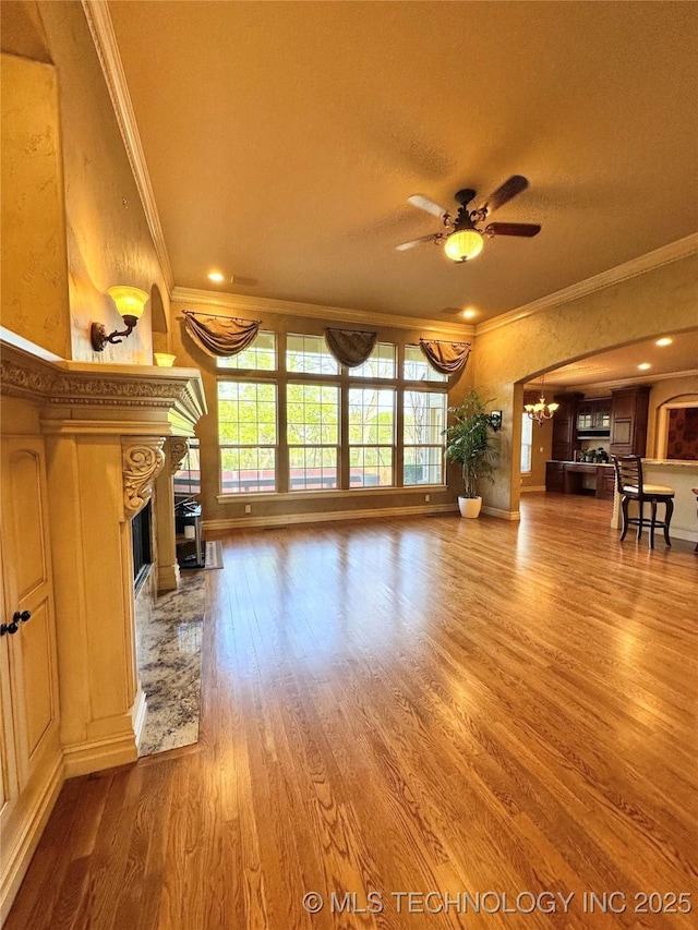 10213 S 88th E Ave, Tulsa, OK 74133 - unfurnished living room with ornamental molding, wood finished floors, a ceiling fan, a chandelier, and a premium fireplace