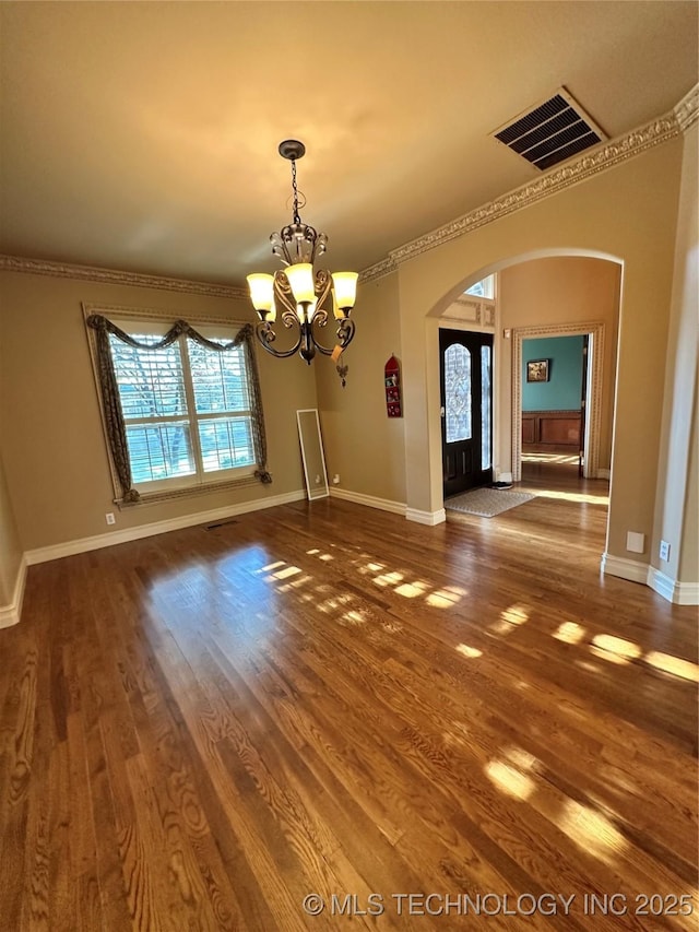 10213 S 88th E Ave, Tulsa, OK 74133 - unfurnished dining area with arched walkways, a chandelier, wood finished floors, and ornamental molding